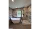 Beautiful bathroom featuring a soaking tub, large glass shower, and modern fixtures, complemented by elegant marble walls at 281 New Hope Dr, Mcdonough, GA 30252