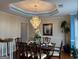 Formal dining room with crystal chandelier, crown molding and set table at 233 Mistybrook Cir, Stone Mountain, GA 30087