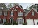 Charming two-story brick home with white trim and shuttered windows at 233 Mistybrook Cir, Stone Mountain, GA 30087
