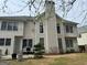 Back exterior view featuring siding, many windows, chimney, and a small patio at 233 Mistybrook Cir, Stone Mountain, GA 30087
