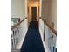 Upstairs hallway with carpet runner, white posts and wooden railing at 233 Mistybrook Cir, Stone Mountain, GA 30087