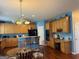 Spacious kitchen with light wood cabinets, center island, breakfast nook, and blue walls at 233 Mistybrook Cir, Stone Mountain, GA 30087