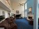 Bright and spacious living room with tall ceilings, fireplace and blue carpet at 233 Mistybrook Cir, Stone Mountain, GA 30087
