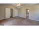 This carpeted bedroom has a ceiling fan, neutral colors and closet for ample storage at 130 Bradley Pl, Mcdonough, GA 30253