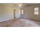 This carpeted bedroom with neutral paint features a ceiling fan and windows for natural light at 130 Bradley Pl, Mcdonough, GA 30253