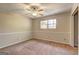 A tan carpeted bedroom features a ceiling fan, chair rail and a window for natural light at 130 Bradley Pl, Mcdonough, GA 30253