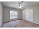 This carpeted bedroom features a ceiling fan, closet and a large window at 130 Bradley Pl, Mcdonough, GA 30253