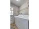 Laundry room with tile flooring, washer and dryer, and a door to the exterior at 130 Bradley Pl, Mcdonough, GA 30253