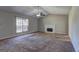 Spacious living room featuring a fireplace, carpet flooring, vaulted ceiling, and lots of natural light at 130 Bradley Pl, Mcdonough, GA 30253