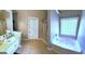 Bathroom features a bathtub and shower combo with single sink vanity at 40 Pebble Brooke Ct, Covington, GA 30016
