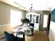 Traditional dining room with a glass-top table, white china cabinet, and chandelier lighting at 40 Pebble Brooke Ct, Covington, GA 30016