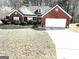 Charming brick home featuring a well-manicured front yard and attached two-car garage at 40 Pebble Brooke Ct, Covington, GA 30016