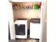 Convenient laundry room includes a washer, dryer, and shelving for storage at 40 Pebble Brooke Ct, Covington, GA 30016