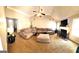 Open living room with large sofa, fireplace, fan, and high ceilings at 40 Pebble Brooke Ct, Covington, GA 30016