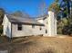 Side view of two-story home with chimney at 6733 Jojanne Ln, Lithonia, GA 30038