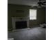 Living room with a white fireplace and mantle, ceiling fan, window and carpet flooring at 6733 Jojanne Ln, Lithonia, GA 30038