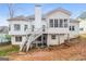 Exterior back of home featuring deck with staircase, sunroom, and white siding at 364 Valleyside Dr, Dallas, GA 30157