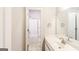 Bathroom with white cabinet and sink, framed mirror, and bathtub/shower combo with sliding glass door at 364 Valleyside Dr, Dallas, GA 30157