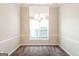 Dining room featuring a large window, modern chandelier, and neutral walls at 364 Valleyside Dr, Dallas, GA 30157