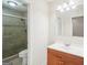 Bathroom featuring a walk-in shower with glass door and vanity with mirror at 3396 Framingham Dr, Lithonia, GA 30038