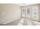 Bright bedroom with neutral walls, new carpet, and two windows at 3396 Framingham Dr, Lithonia, GA 30038