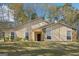 Charming single-story home featuring stone accents, neutral siding and lush landscaping at 3396 Framingham Dr, Lithonia, GA 30038