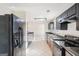Well-appointed kitchen with stainless appliances, tile floor, and dark cabinetry at 3396 Framingham Dr, Lithonia, GA 30038