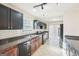 Updated kitchen with stainless steel appliances, dark cabinetry, and ceramic tile flooring at 3396 Framingham Dr, Lithonia, GA 30038