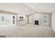 Open-concept living area with a fireplace and views to the kitchen and back yard at 3396 Framingham Dr, Lithonia, GA 30038