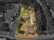 Aerial view showcasing the house with surrounding lot, neighboring houses, and lush greenery at 1001 Stagecoach Rd, Stockbridge, GA 30281