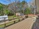 Spacious wooden deck overlooking lush backyard with a detached garage and shed at 1001 Stagecoach Rd, Stockbridge, GA 30281