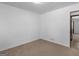 This carpeted bedroom has an open doorway that leads to another room at 1001 Stagecoach Rd, Stockbridge, GA 30281