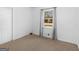 Neutral colored carpeted bedroom showing the window to the outdoors at 1001 Stagecoach Rd, Stockbridge, GA 30281