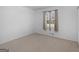 Bedroom with neutral carpet and walls, window with blinds, and minimal decor at 1001 Stagecoach Rd, Stockbridge, GA 30281
