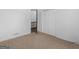 This carpeted bedroom has a closet with sliding doors and an open door at 1001 Stagecoach Rd, Stockbridge, GA 30281