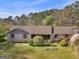 Charming single-story brick home with a well-maintained lawn and mature trees in a serene setting at 1001 Stagecoach Rd, Stockbridge, GA 30281