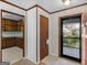 Inviting foyer featuring tile flooring, natural wood trim, and views into the kitchen and porch at 1001 Stagecoach Rd, Stockbridge, GA 30281