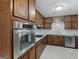 Bright kitchen featuring stainless steel oven and countertops with dark cabinets and tile floors at 1001 Stagecoach Rd, Stockbridge, GA 30281