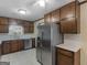 Well-lit kitchen with white countertops, stainless steel appliances, and dark wood cabinets at 1001 Stagecoach Rd, Stockbridge, GA 30281