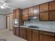 Well-equipped kitchen with wooden cabinetry, stainless steel appliances, and a stylish backsplash at 1001 Stagecoach Rd, Stockbridge, GA 30281