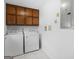 Laundry room with overhead cabinets, tile floors, and a standard washer/dryer set at 1001 Stagecoach Rd, Stockbridge, GA 30281