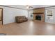 Spacious living room with wood floors, brick fireplace, and ample natural light from large windows at 1001 Stagecoach Rd, Stockbridge, GA 30281