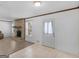 Living area with brick fireplace, tile and wood floors, and neutral wall colors at 1001 Stagecoach Rd, Stockbridge, GA 30281