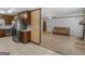 Kitchen with tile flooring flowing into the living room with a brick fireplace and sofa at 1001 Stagecoach Rd, Stockbridge, GA 30281