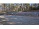 Spacious backyard featuring a retaining wall and serene wooded area at 185 Ridgewood Dr, Fayetteville, GA 30215