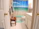 Bathroom with a bright beach themed shower curtain, white cabinets and tile flooring at 185 Ridgewood Dr, Fayetteville, GA 30215
