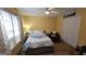 Bright bedroom with natural light from the window, ceiling fan, and a comfortable bed at 185 Ridgewood Dr, Fayetteville, GA 30215