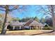 Charming single-story brick home featuring a well-manicured lawn and inviting front porch at 185 Ridgewood Dr, Fayetteville, GA 30215