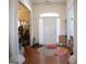 Bright foyer with hardwood floors, white pillars, and a colorful round rug at 185 Ridgewood Dr, Fayetteville, GA 30215
