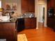 Functional kitchen area with wooden cabinets, granite countertops, and modern appliances at 185 Ridgewood Dr, Fayetteville, GA 30215